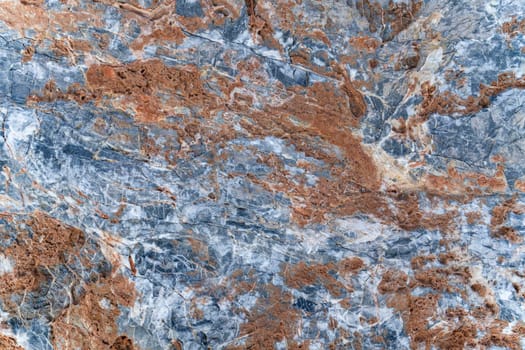 Background texture of stone slab with gray-orange pattern. Layer of rust on surface of stone.