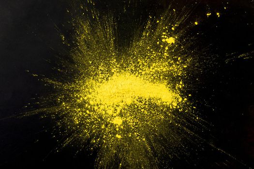 explosion yellow colored powder black surface. Resolution and high quality beautiful photo