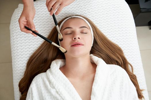 Face Skin Care. Woman Gets Brushes Treatment At Beauty Clinic