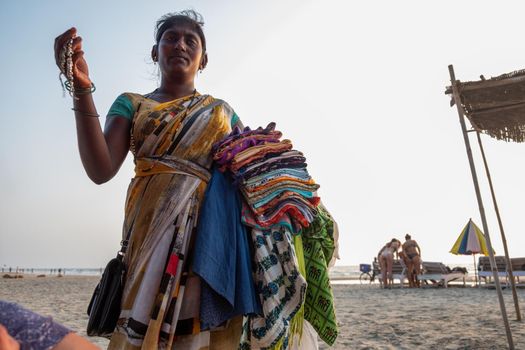 Indian woman souvenir seller on the beach, Goa, India