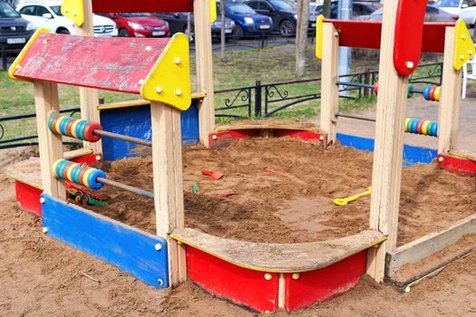 Sandbox with toys on a colorful children playground. Urban area childhood concept