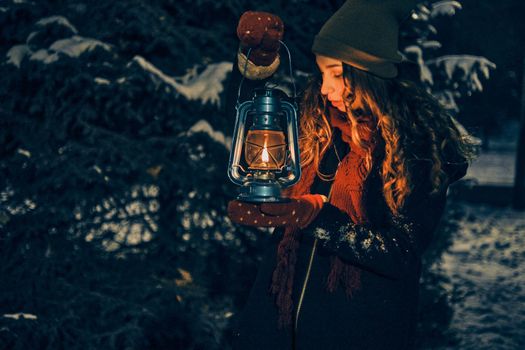 Young girl with lantern in winter forest fairy tale, book cover, christmas time