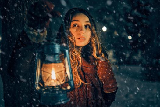 Young girl with lantern in winter forest fairy tale, book cover, christmas time