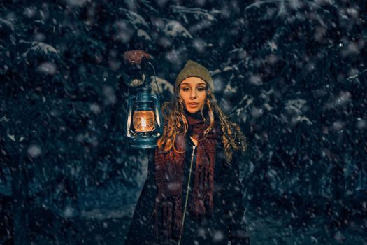 Young girl with lantern in winter forest fairy tale, book cover, christmas time