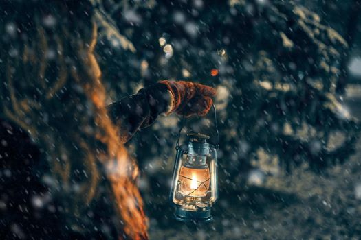 Young girl with lantern in winter forest fairy tale, book cover, christmas time, closeup