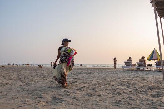 Indian woman souvenir seller on the beach, Goa, India