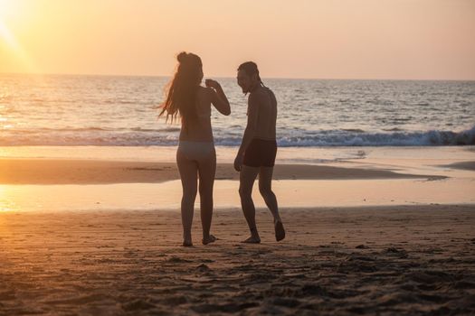 Silhouette of a young couple together at the beach, Goa, India