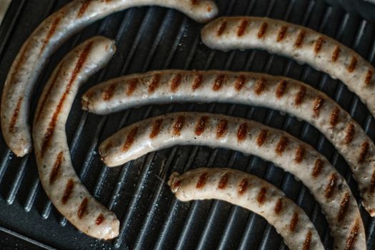 Grilled sausages are cooked, close up shot