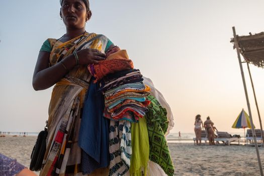 Indian woman souvenir seller on the beach, Goa, India