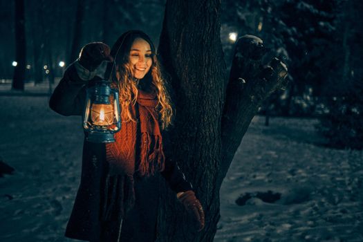 Young girl with lantern in winter forest fairy tale, book cover, christmas time