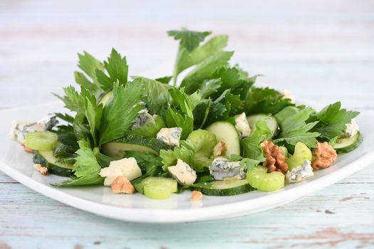  Celery leaves and stalks salad with fresh cucumber slices, blue cheese, crushed nuts.