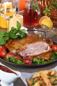 Sliced baked turkey drumstick on a vegetable tray at the Thanksgiving dinner table