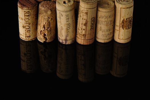 Tashkent, Uzbekistan - October 6, 2009 : Heap of old wine corks on black background with reflection. Studio photography