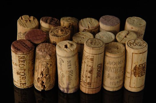 Tashkent, Uzbekistan - October 6, 2009 : Heap of old wine corks on black background with reflection. Studio photography