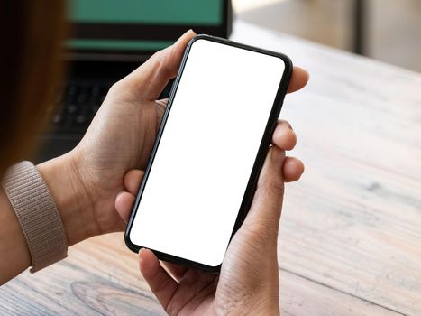 Top view Woman sitting and holding blank screen mock up mobile phone.