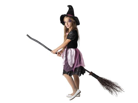 Halloween party witch girl on broom isolated on white background, adorable cute young kid acting to be witch in studio