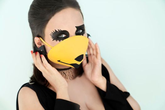 Girl with halloween makeup and orange medical mask on face. Halloween during the coronavirus.