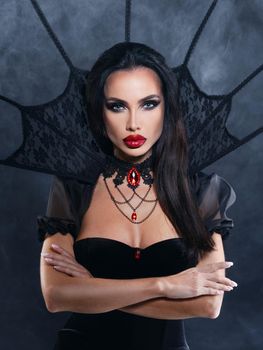 Beautiful Young woman as sexy vampire in black dress - halloween portrait