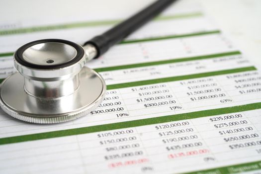 Stethoscope on spreadsheet paper, Finance, Account, Statistics, Investment, Analytic research data economy spreadsheet and Business company concept.