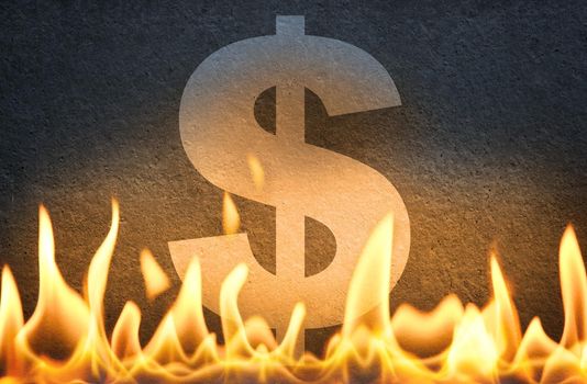 US dollar currency symbol sign burning in fire flames, as symbol of American economy crisis, decline and USA market crash or disruption