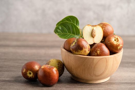 Jujube fruit or Chinese Dates in wooden bowl, healthy food.