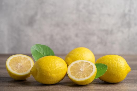 Lemon ripe fresh fruit with leaf on wooden background with copy space