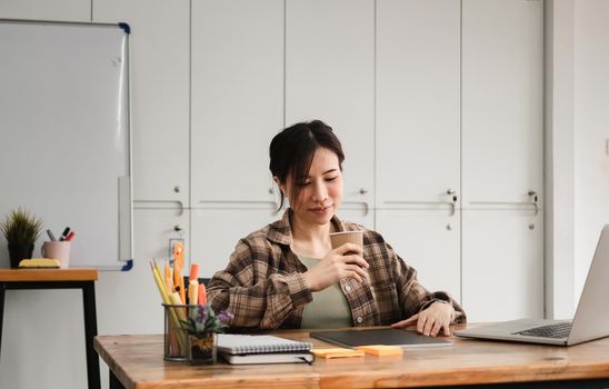 Cropped photo of asian woman working or learning on laptop indoors- educational course or training, seminar, education online concept.