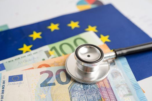 Black stethoscope on EU flag in europe with banknotes money, Business and finance concept.