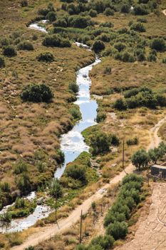 The Vinalopo River between vegetation and mountain landscape in Novelda, Alicante, Spain