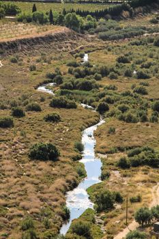The Vinalopo River between vegetation and mountain landscape in Novelda, Alicante, Spain