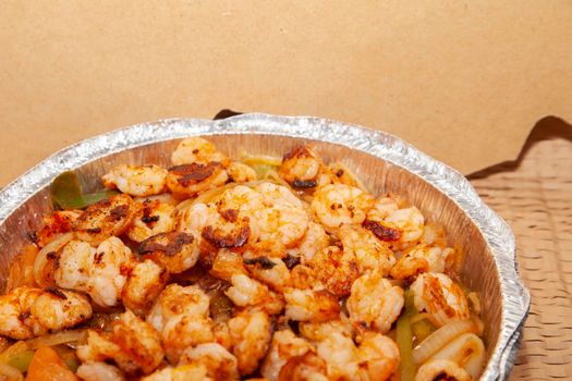 Oven-roasted shrimp and vegetables in a takeout tin