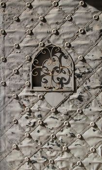 Old forged metal door in Santa Maria Magdalena Sanctuary in Novelda, Alicante, Spain.