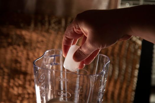 Dropping an ice cube into an empty blender