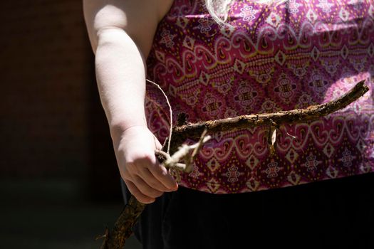 One woman holding a stick in her hand