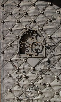 Old forged metal door in Santa Maria Magdalena Sanctuary in Novelda, Alicante, Spain.