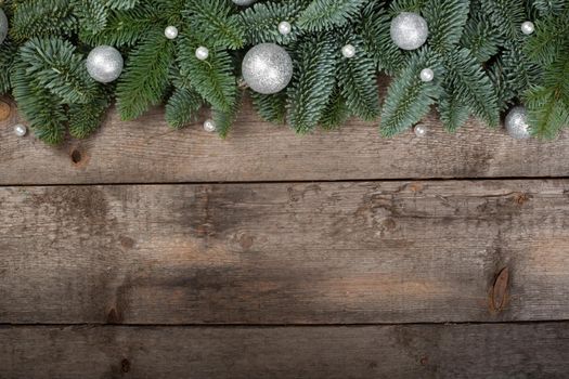 Spruce twigs on a wooden background with copy space for text flat lay top view template