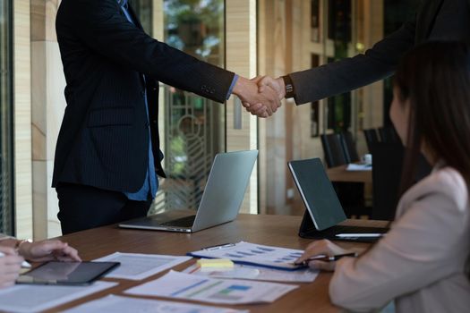 Businessman and partner handshake for the new agreement after sign in agreement contract with work together