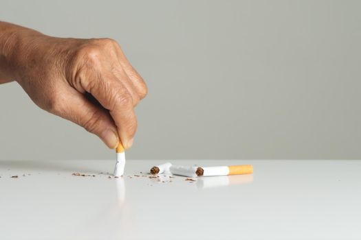 Quit smoking, no tobacco day, mother hands breaking the cigarette