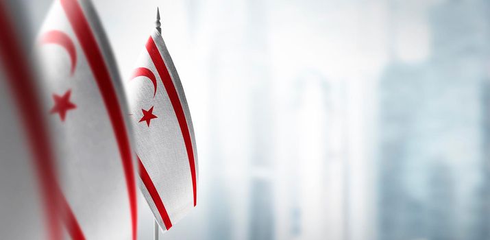 Small flags of Northern Cyprus on a blurry background of the city.