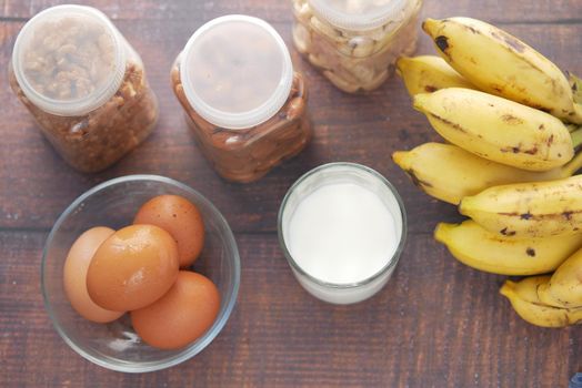 almond nut, milk and banana on table .