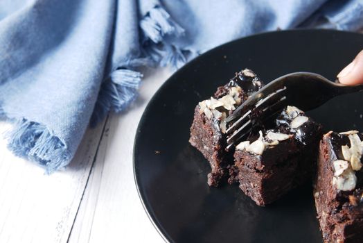 slice of brownie on plate on table .