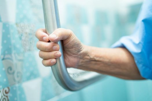 Asian senior or elderly old lady woman patient use slope walkway handle security with help support assistant in nursing hospital ward; healthy strong medical concept.