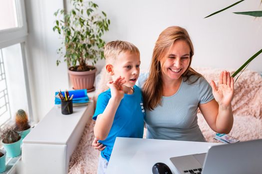 Mother with kid trying to work from home during quarantine. Stay at home, work from home concept during coronavirus pandemic