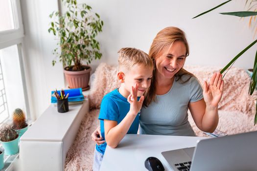 Mother with kid trying to work from home during quarantine. Stay at home, work from home concept during coronavirus pandemic