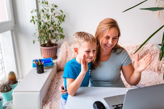 Mother with kid trying to work from home during quarantine. Stay at home, work from home concept during coronavirus pandemic