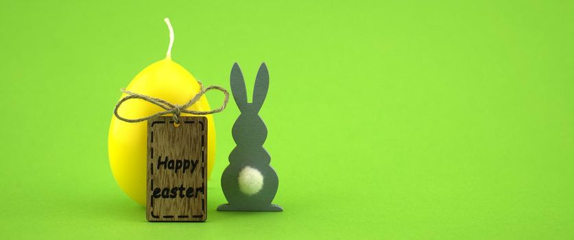 Minimalistic style Easter banner and wooden label with text "Happy Easter" on green background with free copy space for text