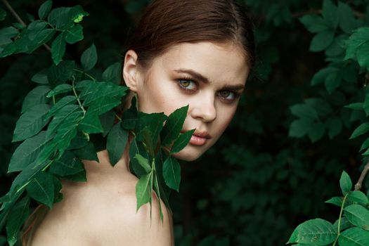 portrait of a woman Cosmetology nature green leaves glamor Lifestyle. High quality photo