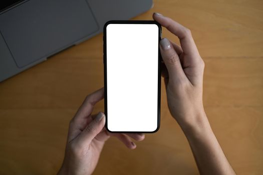 A Man hand holding smartphone device with blank screen. Blank screen for your advertising