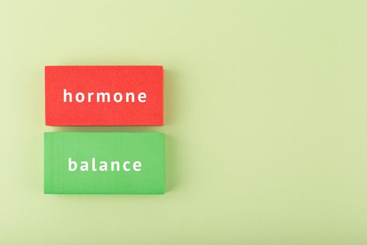 Minimal hormone balance concept with copy space. Inscription on multicolored tablets, health care and medical concept.