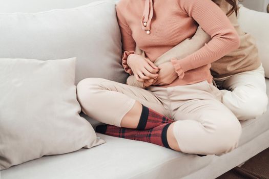 Young woman hugging her friend at home.